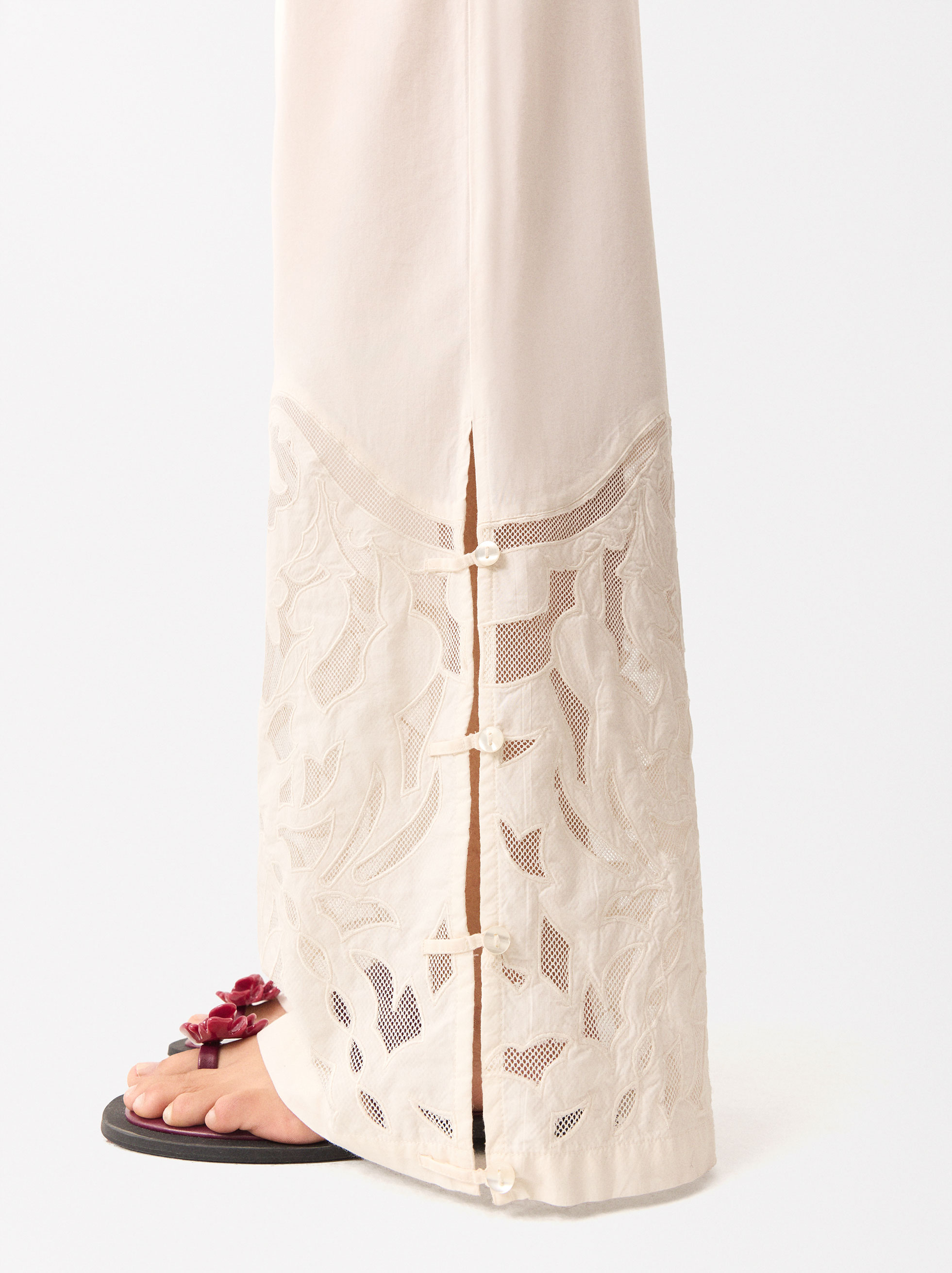 White cotton pants with embroidered detailing at hem by Free